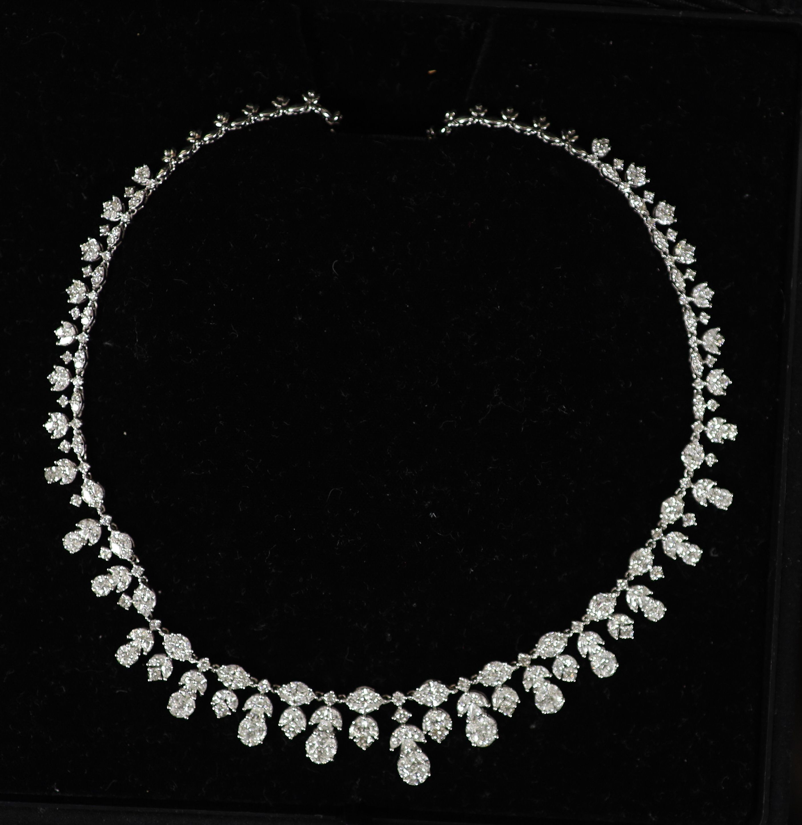 A modern continental 18k white gold and diamond cluster set drop fringe necklace